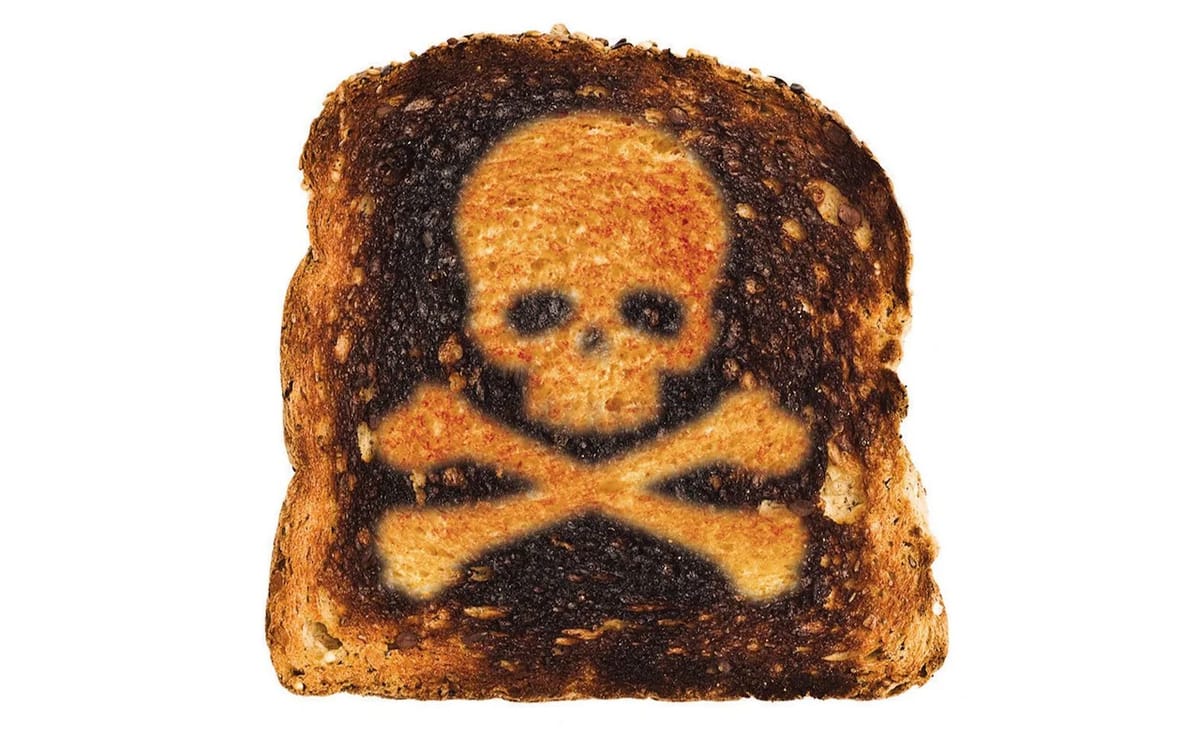 Burnt toast with skull and cross bones on it.